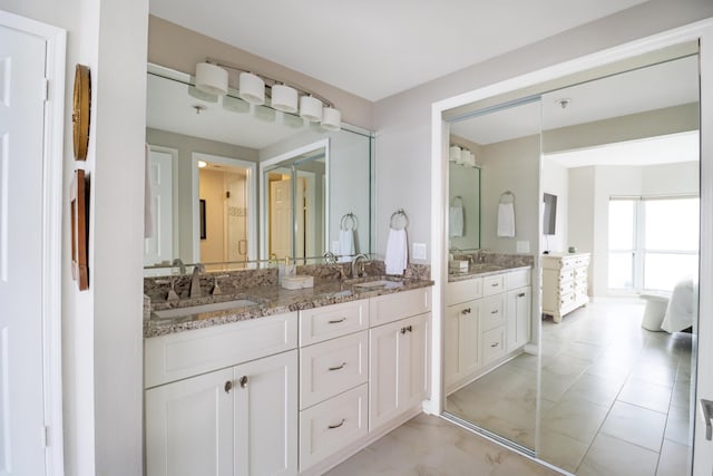 bathroom featuring double vanity and a sink