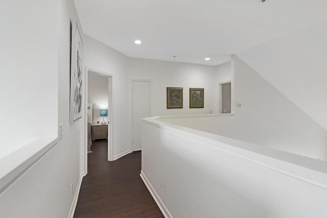 hall with recessed lighting, dark wood-type flooring, and baseboards