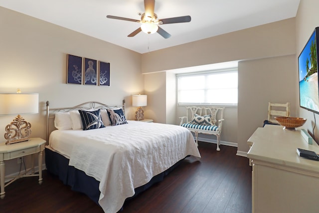 bedroom with baseboards, dark wood finished floors, and a ceiling fan