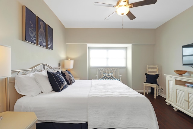 bedroom with ceiling fan, dark wood-type flooring, and baseboards