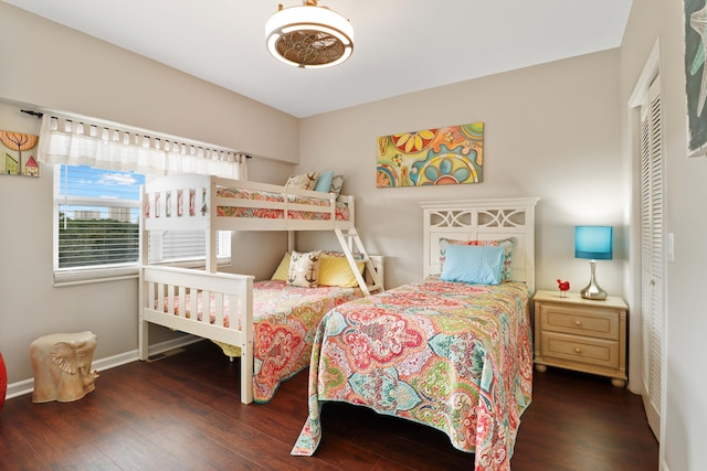 bedroom featuring a closet, baseboards, and wood finished floors