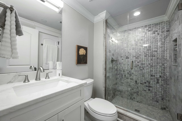 full bath featuring vanity, toilet, a stall shower, and ornamental molding