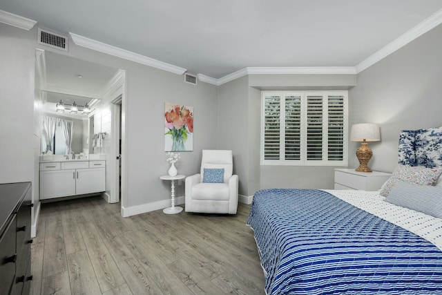 bedroom with visible vents, light wood-style flooring, baseboards, and ornamental molding