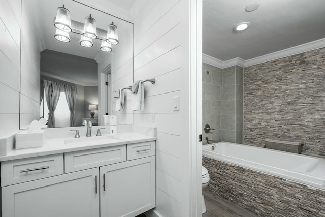 bathroom featuring vanity, wood finished floors, crown molding, toilet, and tile walls