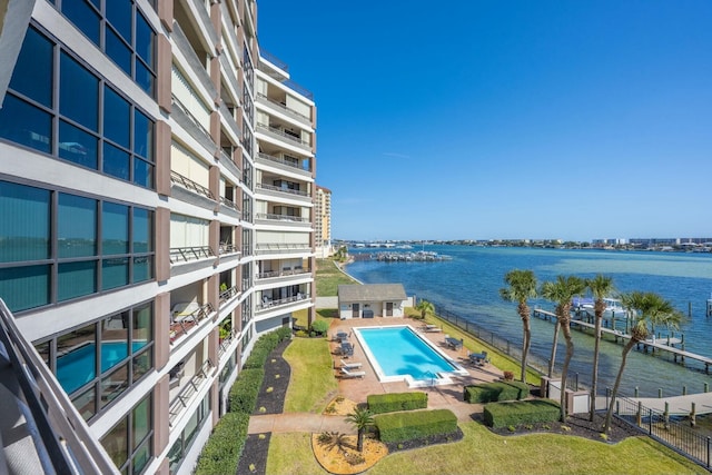 pool with a water view and fence