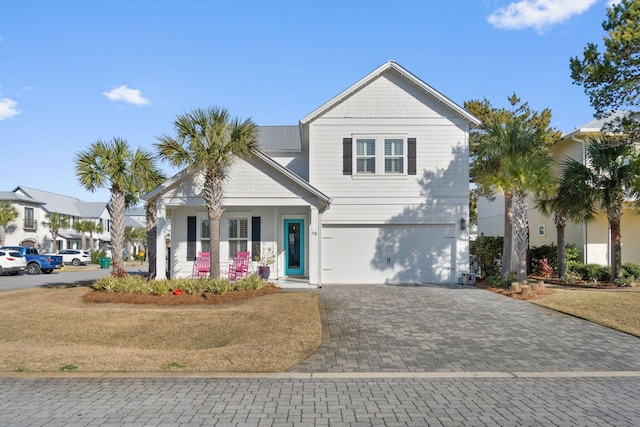 view of front of home with a garage and decorative driveway