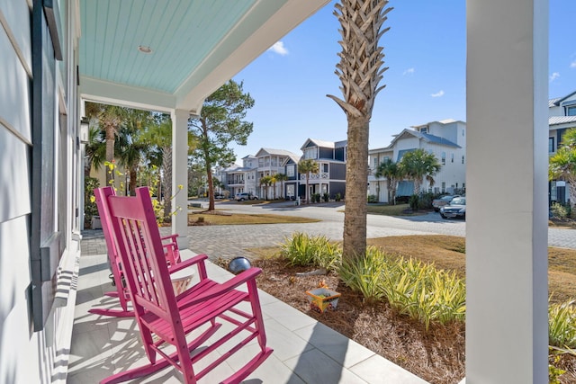 view of patio / terrace featuring a residential view and a porch