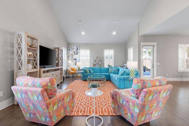 living room with high vaulted ceiling, wood finished floors, visible vents, and baseboards