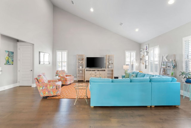 living area with baseboards, wood finished floors, and recessed lighting