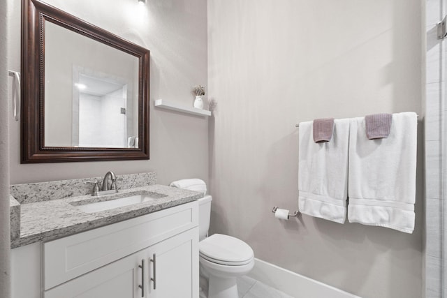 bathroom featuring tile patterned flooring, vanity, and toilet