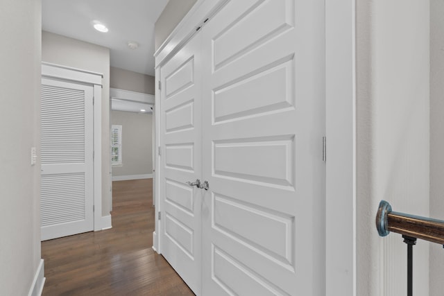 hallway featuring dark wood-style floors, recessed lighting, and baseboards