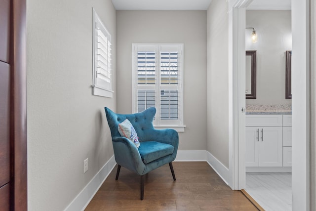 sitting room with wood finished floors and baseboards