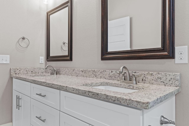 bathroom featuring double vanity and a sink