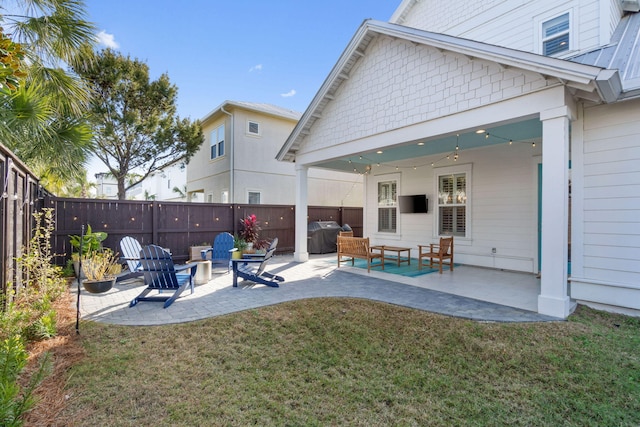 exterior space with grilling area and a fenced backyard