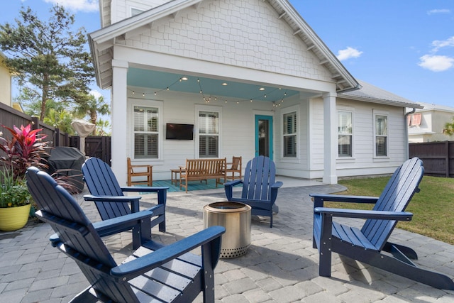 view of patio / terrace featuring an outdoor fire pit and a fenced backyard