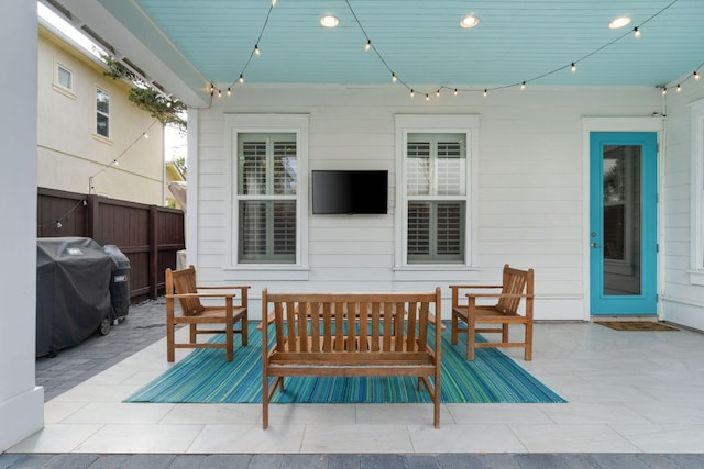 view of patio with grilling area and fence