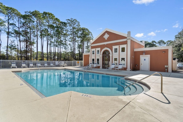 community pool featuring a patio area and fence