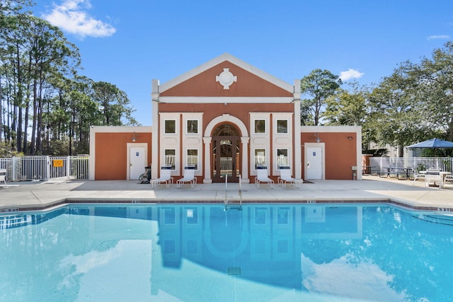 community pool featuring a patio area and fence