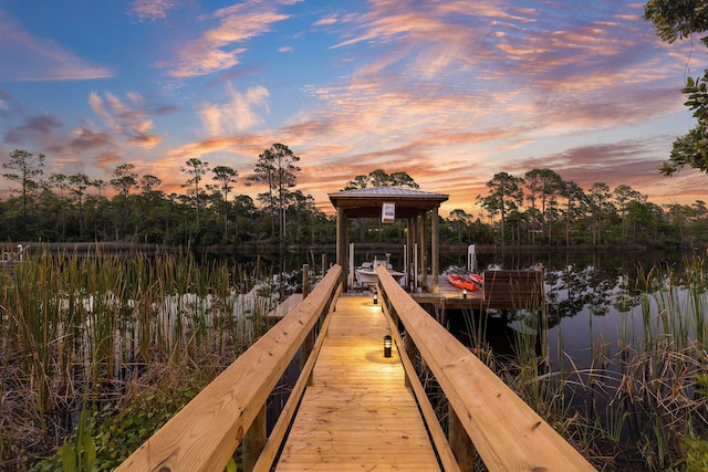 view of dock with boat lift and a water view