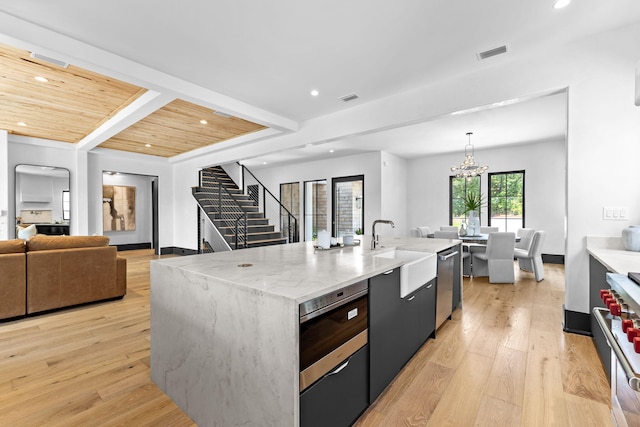 kitchen with open floor plan, light wood-style floors, visible vents, and stainless steel appliances