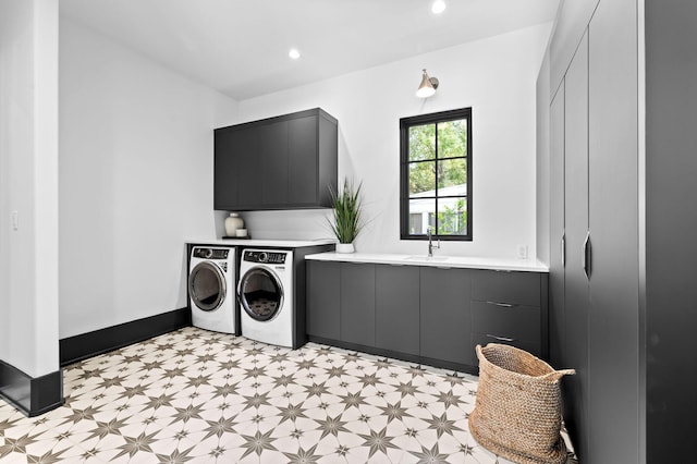 washroom with baseboards, washing machine and dryer, light floors, recessed lighting, and cabinet space