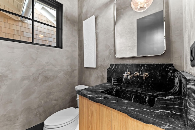 bathroom featuring toilet and vanity