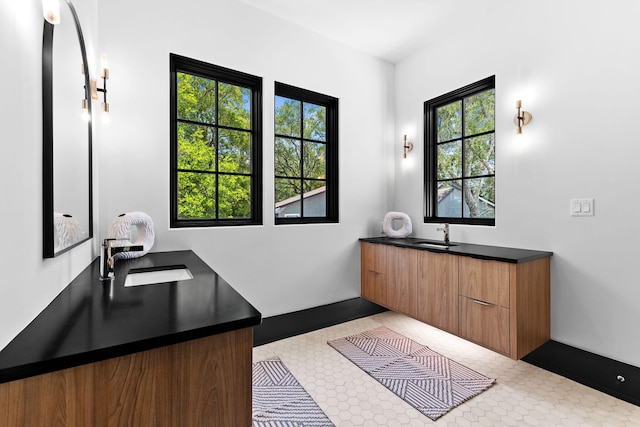 bathroom featuring baseboards and vanity