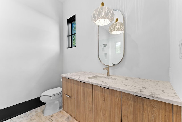 bathroom with vanity and toilet