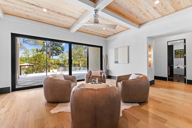 living room featuring beam ceiling, coffered ceiling, wooden ceiling, light wood finished floors, and ceiling fan