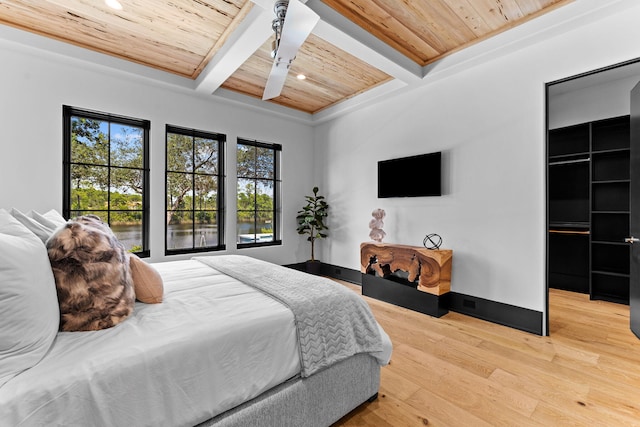 bedroom featuring beamed ceiling, coffered ceiling, wood ceiling, and light wood finished floors