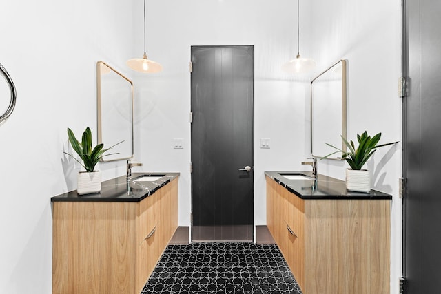 bathroom with a sink and two vanities