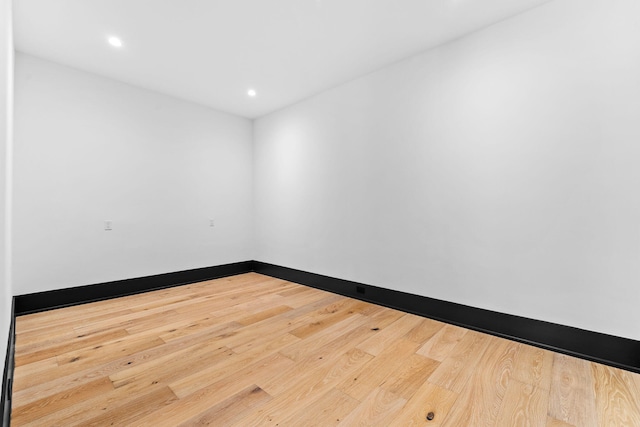 unfurnished room featuring recessed lighting, baseboards, and wood finished floors