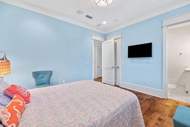 bedroom featuring recessed lighting, visible vents, ensuite bath, wood finished floors, and baseboards