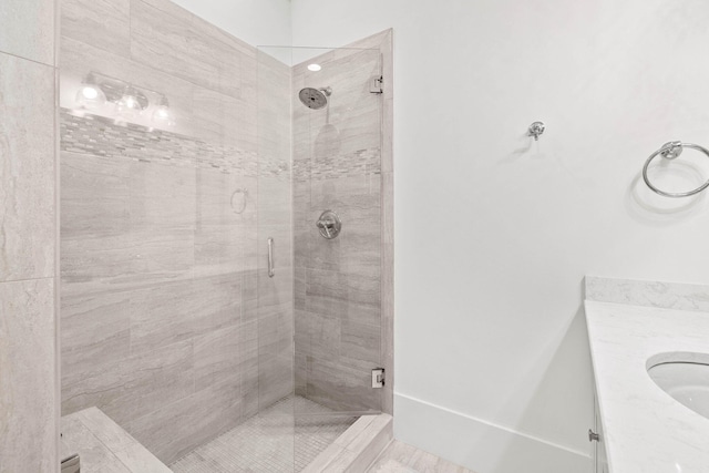 full bathroom featuring a stall shower and vanity