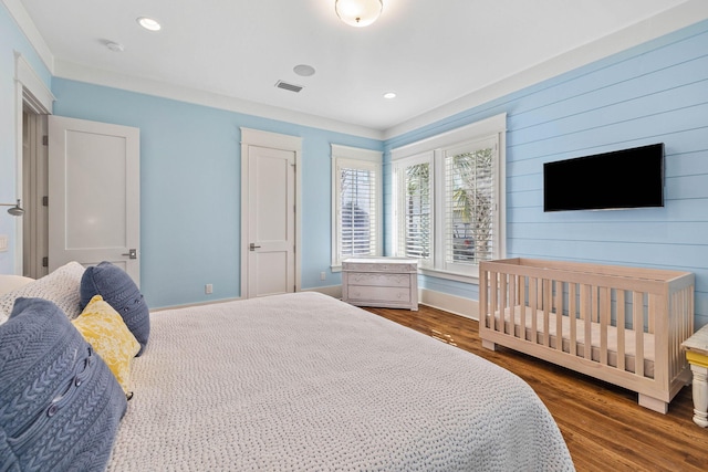 bedroom with recessed lighting, wood finished floors, and baseboards