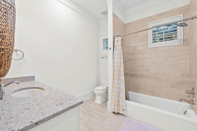 bathroom with visible vents, shower / tub combo with curtain, vanity, and toilet