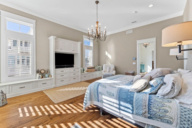 bedroom with light wood-style floors, visible vents, a chandelier, and crown molding