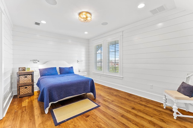 bedroom featuring baseboards, visible vents, wood finished floors, and recessed lighting