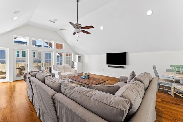 living area with ceiling fan, light wood-style flooring, visible vents, vaulted ceiling, and french doors