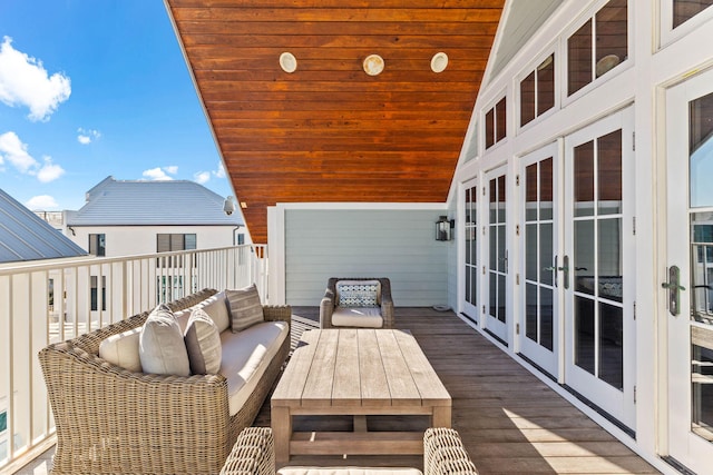 wooden terrace featuring french doors and outdoor lounge area