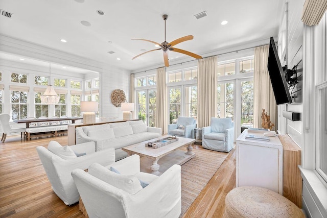 living area with visible vents, recessed lighting, and light wood-type flooring