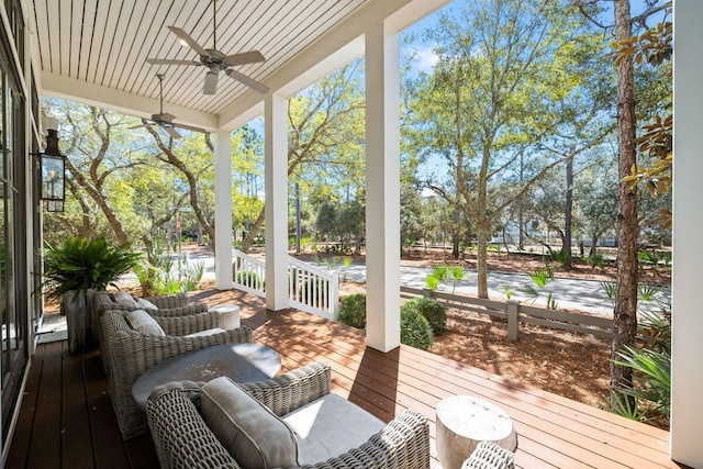 wooden terrace with a porch and ceiling fan