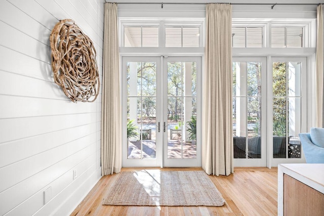 doorway featuring french doors, wood finished floors, and a wealth of natural light