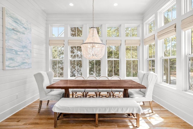 sunroom / solarium featuring a notable chandelier