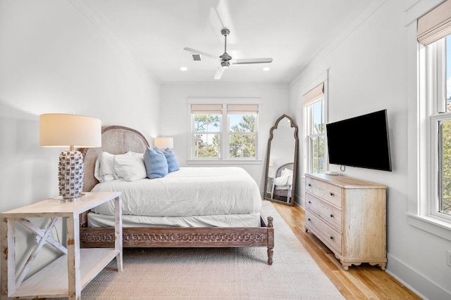 bedroom with visible vents, light wood-style flooring, ornamental molding, recessed lighting, and baseboards