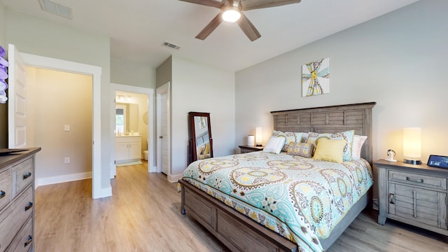 bedroom featuring light wood-style floors, visible vents, and baseboards