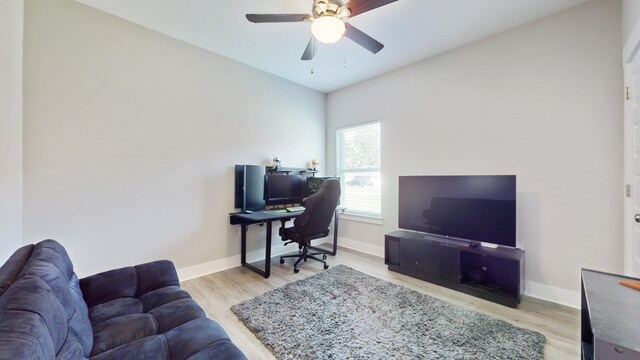 office featuring ceiling fan, baseboards, and wood finished floors