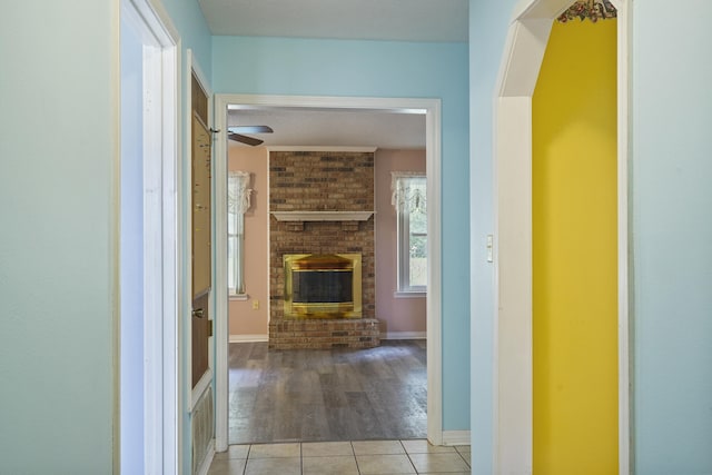 hallway with baseboards and tile patterned floors