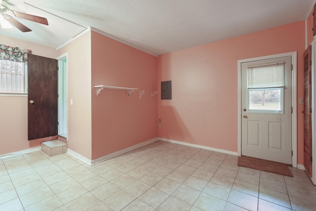 foyer featuring ceiling fan, electric panel, plenty of natural light, and light tile patterned floors