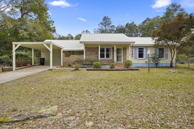 ranch-style house featuring metal roof, an attached carport, fence, a front lawn, and brick siding